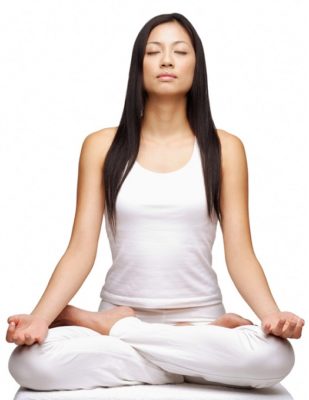 Woman practicing yoga, sitting in lotus position, eyes closed